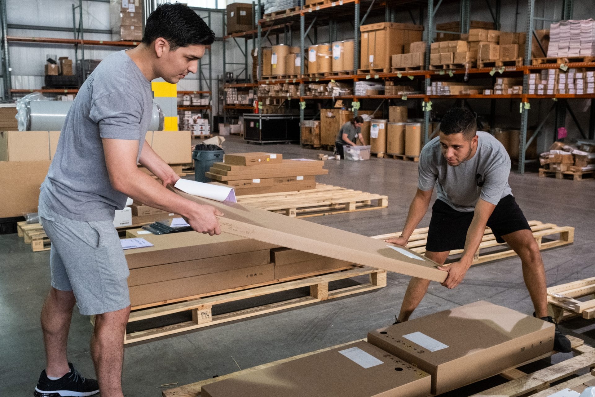 Two men moving a box while shipping and receiving Nashville TN